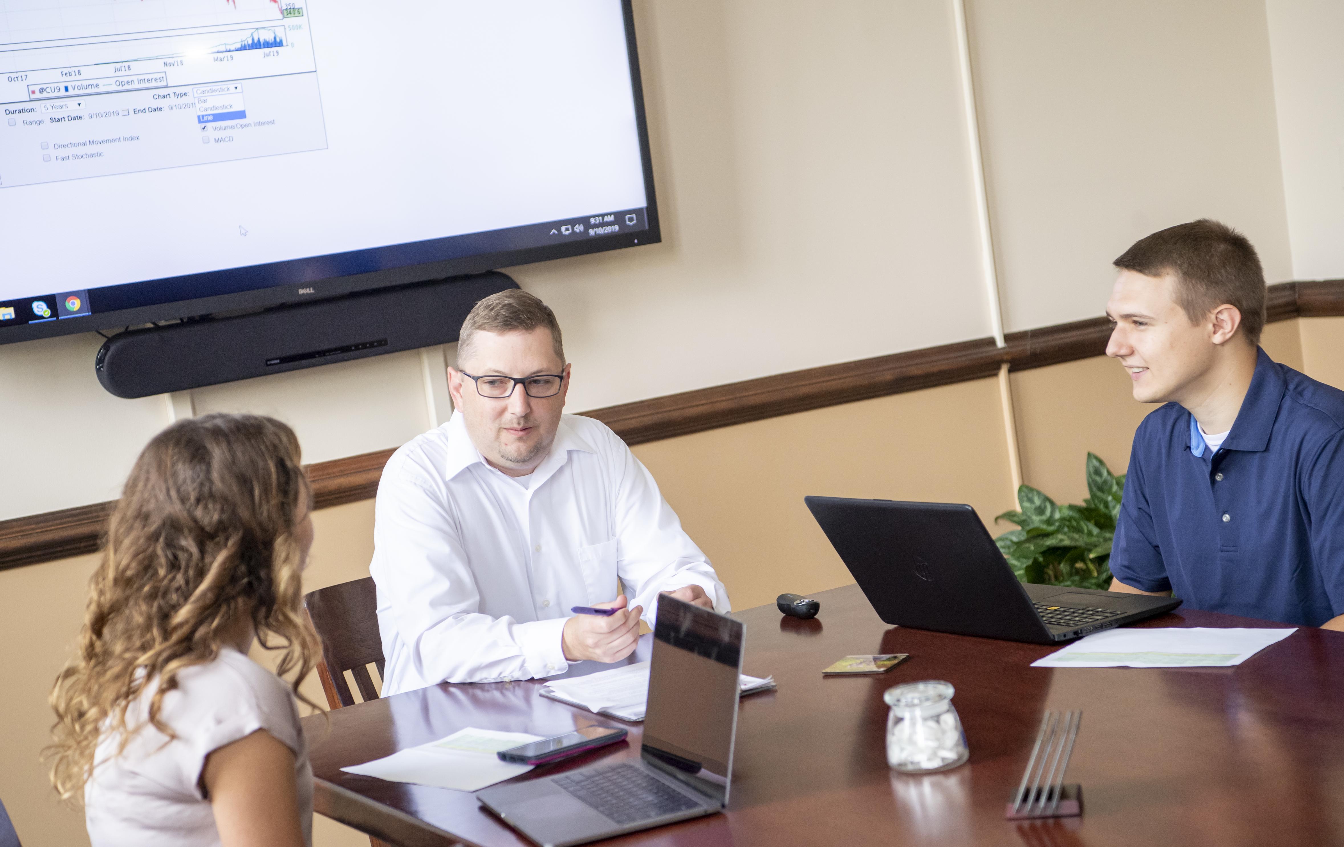 Students working with an instructor at a desk