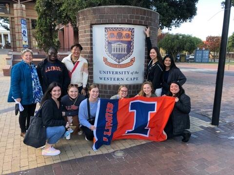 South Africa study abroad group with Illini flag