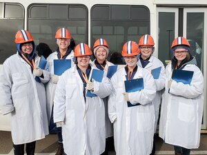 Meat judging team standing outside of bus