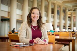 Student sitting at a desk in the library