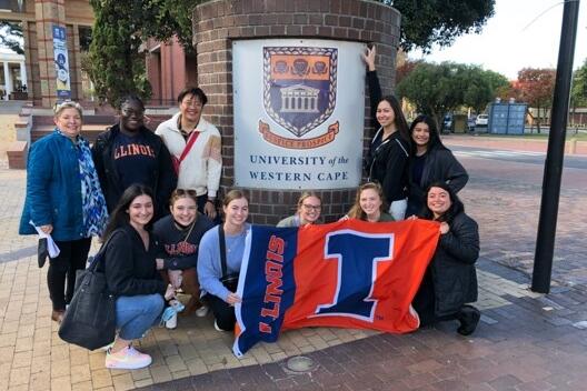 South Africa study abroad group with an Illini flag