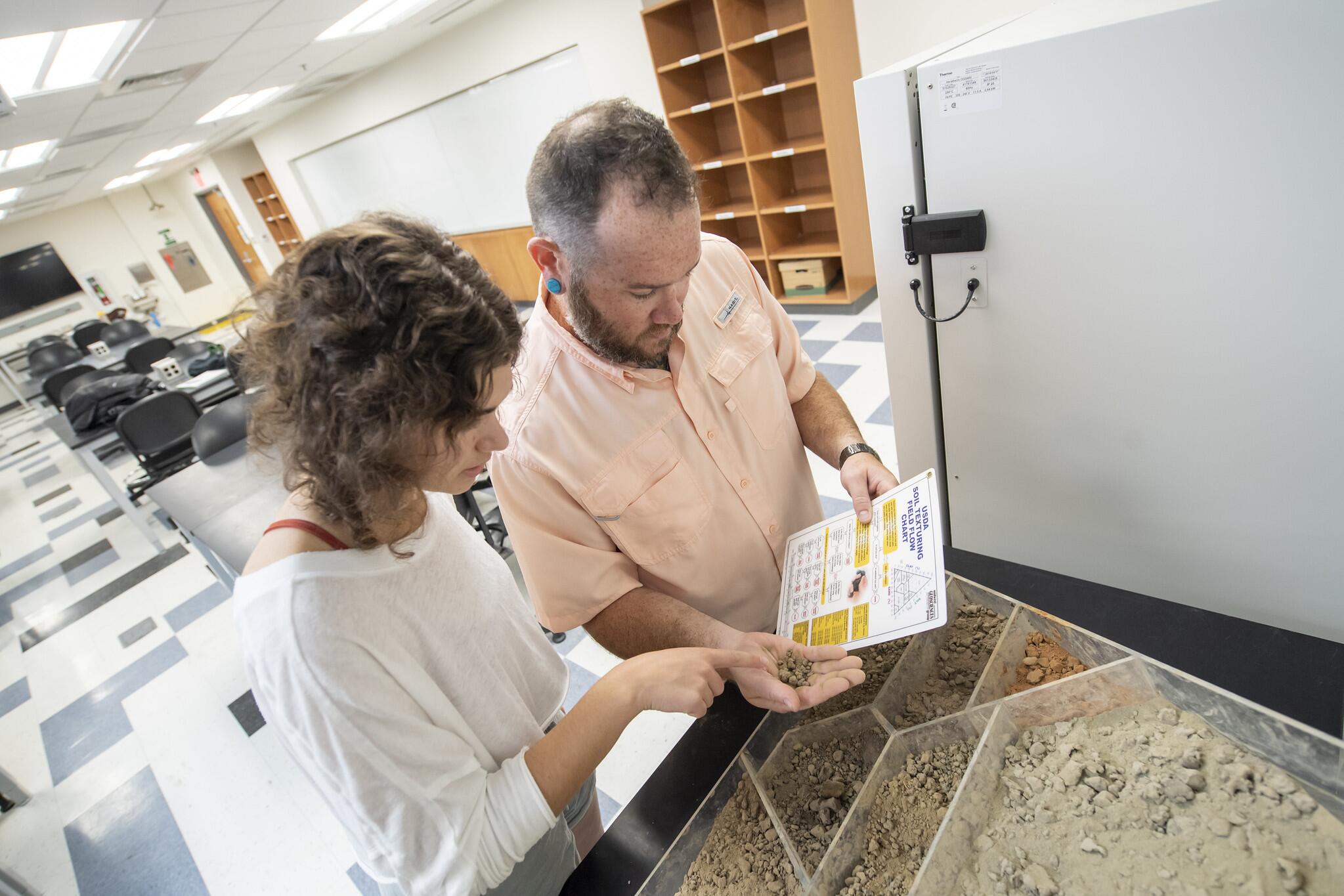 Students studying sand samples.