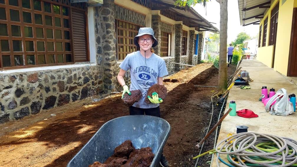 Study abroad student holding soil