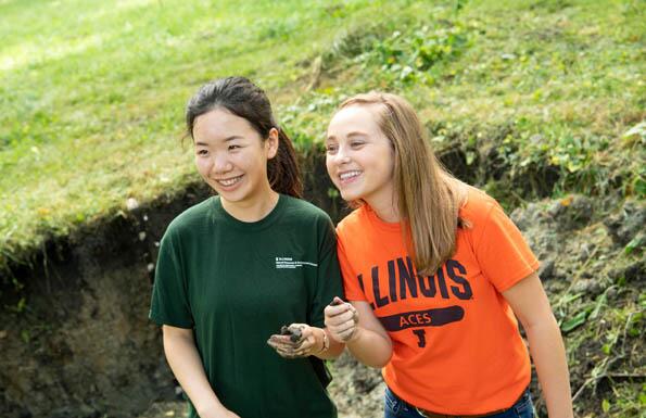 Students smiling and holding soil samples