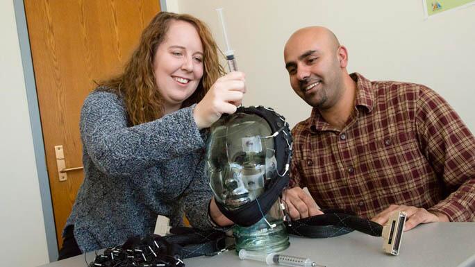 Students working on a bust